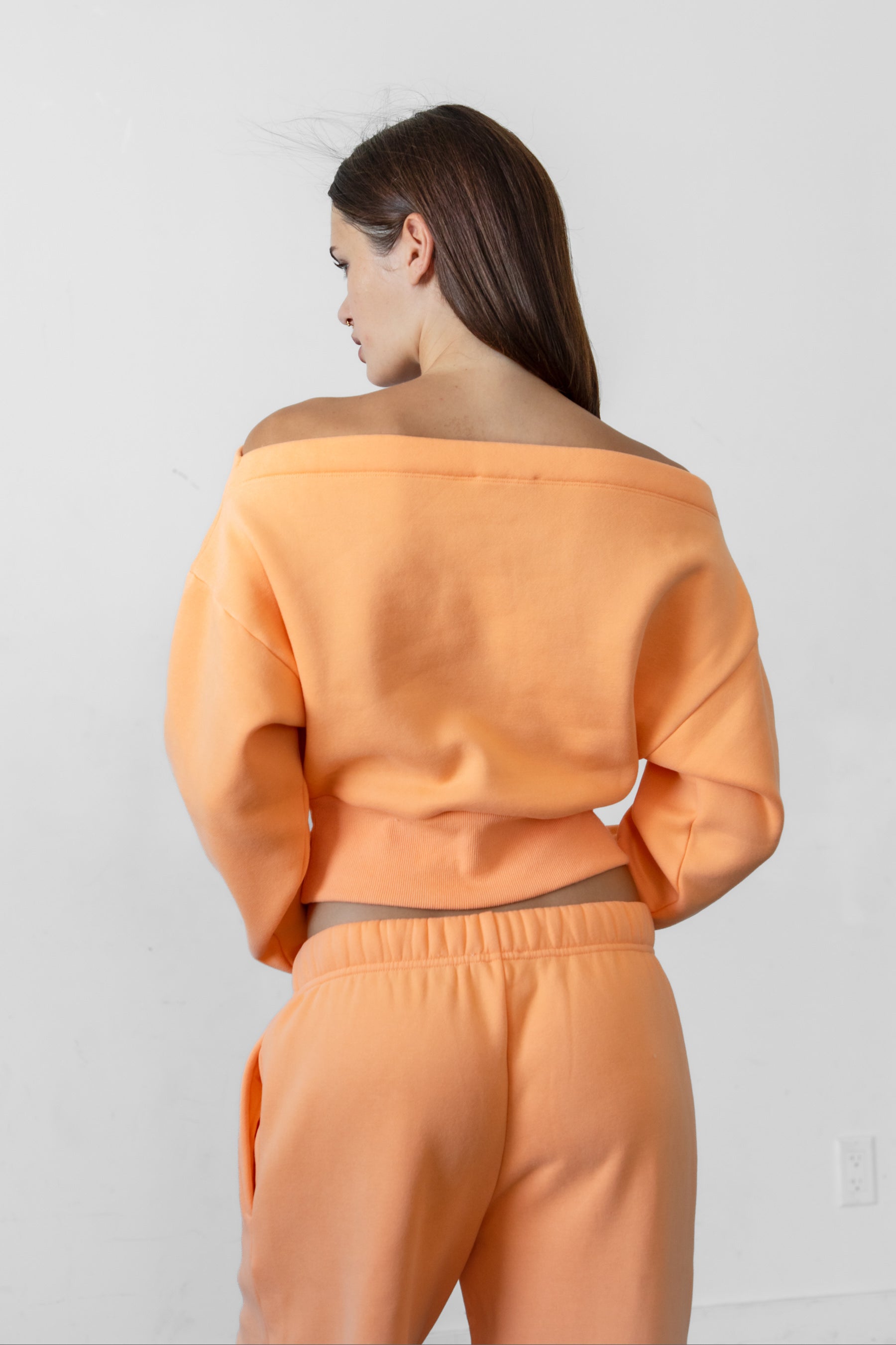 Woman wearing LANI mock neck cloud fleece sweatshirt featuring soft cotton blend cloud fleece fabric, ribbed mock neckline, relaxed oversized fit, dropped shoulder design, long sleeves with ribbed cuffs, triangle stitch detail at center front, and ribbed hem for a cozy comfortable finish.