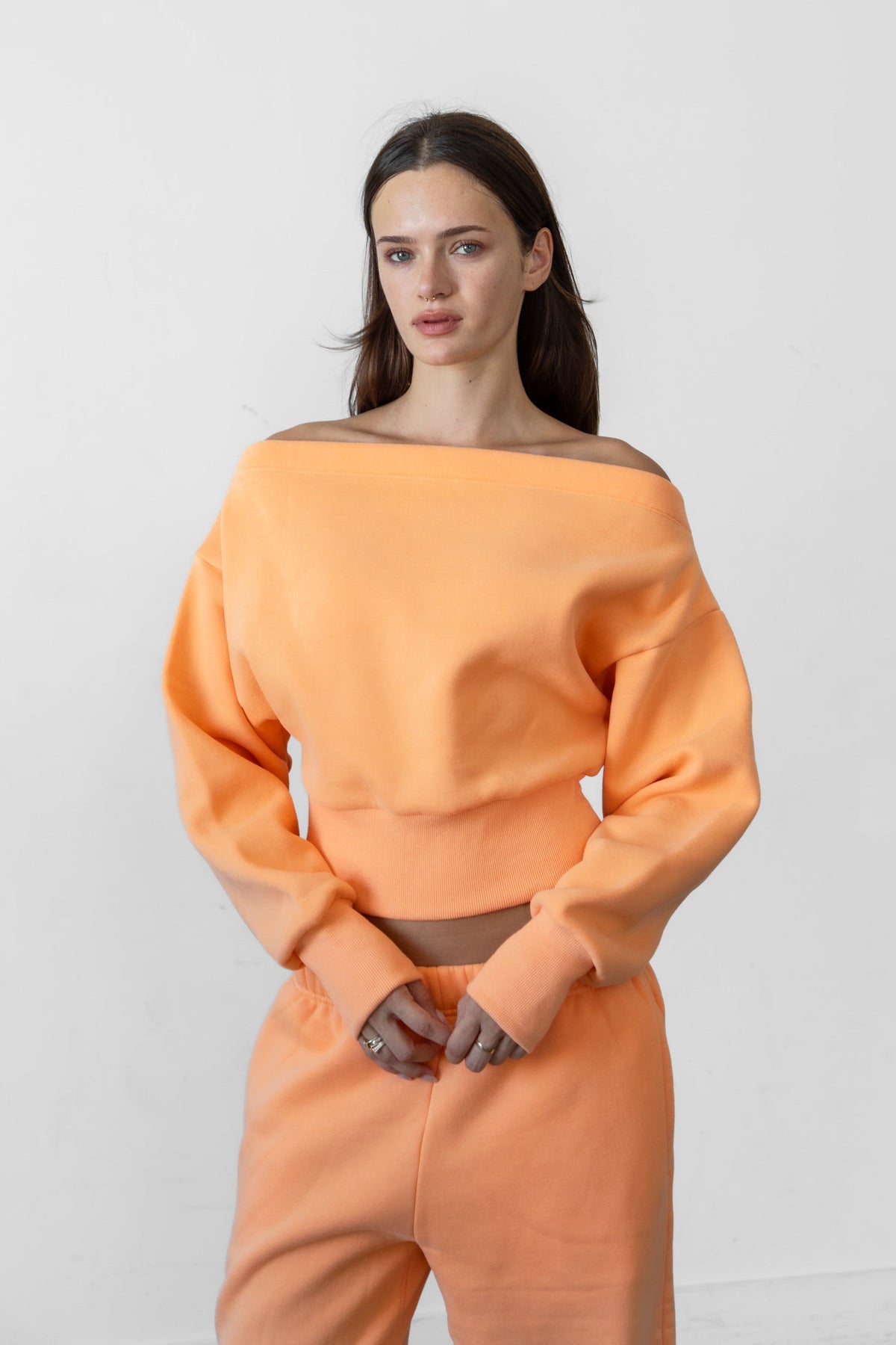 Woman wearing LANI mock neck cloud fleece sweatshirt featuring soft cotton blend cloud fleece fabric, ribbed mock neckline, relaxed oversized fit, dropped shoulder design, long sleeves with ribbed cuffs, triangle stitch detail at center front, and ribbed hem for a cozy comfortable finish.