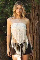 Woman wearing VEYONA beaded sequin tassel scarf top featuring a strapless pointed scarf silhouette, allover sequin and bead embroidery, knotted tassel fringe hem, double strap self tie back design, and lightweight chiffon fabric with bust lining and a draped front shape.