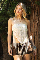 Woman wearing VEYONA beaded sequin tassel scarf top featuring a strapless pointed scarf silhouette, allover sequin and bead embroidery, knotted tassel fringe hem, double strap self tie back design, and lightweight chiffon fabric with bust lining and a draped front shape.