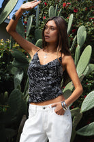 Woman wearing TIC TOC TL31684 AURYA chiffon sequin beaded cowl neck top featuring a draped cowl neckline, floral sequin and beaded embroidery, thin adjustable straps with cross back detail, fitted cropped silhouette, and asymmetrical hemline for a feminine festival and night-out look.