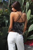 Woman wearing TIC TOC TL31684 AURYA chiffon sequin beaded cowl neck top featuring a draped cowl neckline, floral sequin and beaded embroidery, thin adjustable straps with cross back detail, fitted cropped silhouette, and asymmetrical hemline for a feminine festival and night-out look.