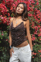 Woman wearing TIC TOC TL31684 AURYA chiffon sequin beaded cowl neck top featuring a draped cowl neckline, floral sequin and beaded embroidery, thin adjustable straps with cross back detail, fitted cropped silhouette, and asymmetrical hemline for a feminine festival and night-out look.