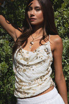 Woman wearing TIC TOC TL31684 AURYA chiffon sequin beaded cowl neck top featuring a draped cowl neckline, floral sequin and beaded embroidery, thin adjustable straps with cross back detail, fitted cropped silhouette, and asymmetrical hemline for a feminine festival and night-out look.
