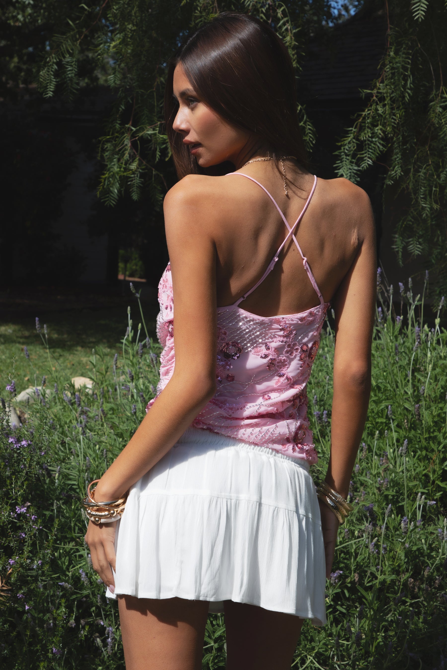 Woman wearing TIC TOC TL31684 AURYA chiffon sequin beaded cowl neck top featuring a draped cowl neckline, floral sequin and beaded embroidery, thin adjustable straps with cross back detail, fitted cropped silhouette, and asymmetrical hemline for a feminine festival and night-out look.