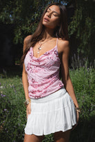 Woman wearing TIC TOC TL31684 AURYA chiffon sequin beaded cowl neck top featuring a draped cowl neckline, floral sequin and beaded embroidery, thin adjustable straps with cross back detail, fitted cropped silhouette, and asymmetrical hemline for a feminine festival and night-out look.