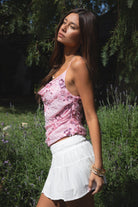 Woman wearing TIC TOC TL31684 AURYA chiffon sequin beaded cowl neck top featuring a draped cowl neckline, floral sequin and beaded embroidery, thin adjustable straps with cross back detail, fitted cropped silhouette, and asymmetrical hemline for a feminine festival and night-out look.