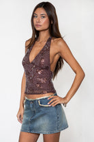 Woman wearing TIC TOC TL31688 VESTRA sequin beaded mesh halter top featuring sheer mesh fabric with floral sequin and beaded embroidery, a deep V-neckline with halter tie, fitted silhouette, open back with adjustable self-tie closure, and a fully lined interior for a bold festival and night-out look.