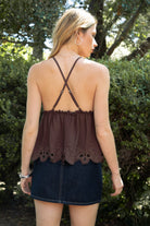 Woman wearing TIC TOC TL31885 ALUME gauze embroidery babydoll top featuring lightweight cotton gauze fabric, a V neckline with embroidered bust detail, scalloped eyelet hem with floral embroidery, elastic under bust shaping, and thin adjustable cross back straps for a soft feminine summer look.