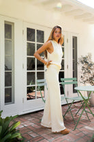 Woman wearing SONORA sweater knit one shoulder wide leg set featuring a soft stretch knit fabric, asymmetrical one shoulder sleeveless top, high-rise wide leg pants with stretch waistband, and a relaxed draped silhouette for a comfortable yet elevated look.