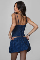 MANON Stripped Stretch Denim Skirt Set 
Denim Bustier Top 
Low Scoop Neckline 
Exposed Self Bow Detail 
Adjustable Shoulder Straps 
Adjustable Lace Up Tie At Center Back 
Hidden Zipper Closure At Side 
Matching Low Rise Mini Skirt 
Stretch Waistband
Built In Under Shorts
