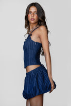 MANON Stripped Stretch Denim Skirt Set 
Denim Bustier Top 
Low Scoop Neckline 
Exposed Self Bow Detail 
Adjustable Shoulder Straps 
Adjustable Lace Up Tie At Center Back 
Hidden Zipper Closure At Side 
Matching Low Rise Mini Skirt 
Stretch Waistband
Built In Under Shorts
