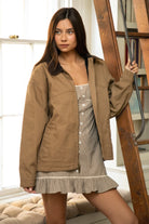 Woman wearing TIC TOC TT31817-SABLETON SABLETON oversized canvas twill jacket featuring an oversized vintage fit, front zip closure, contrast corduroy collar, two side pockets, snap button cuffs with drop shoulder fit, and chest and back stitched detailing, styled over casual basics for a western-inspired everyday transitional look.