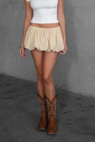 Woman wearing TIC TOC MSH30979-MADYEE ADYEE gingham bubble skirt with built-in shorts featuring a bubble hem silhouette, stretch elastic waistband, and easy pull-on fit for a playful western festival look.