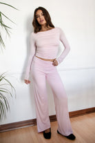 Woman wearing the TIC TOC PH31588BA SORA blush fold over straight leg leggings featuring a low rise waistline, smooth stretch fabric, and straight leg finish with the matching top against a white wall.