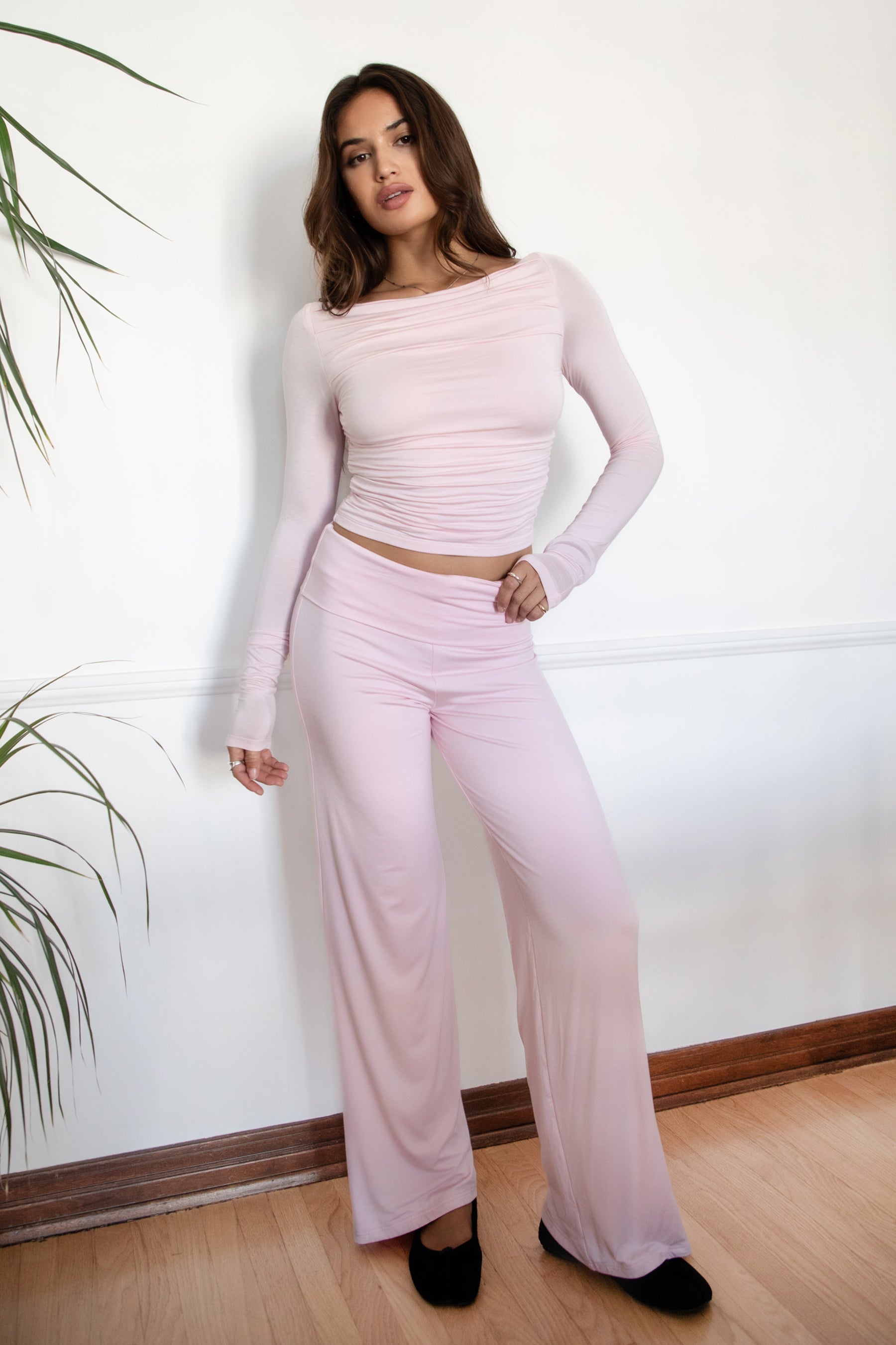 Woman wearing the TIC TOC PH31588BA SORA blush fold over straight leg leggings featuring a low rise waistline, smooth stretch fabric, and straight leg finish with the matching top against a white wall.