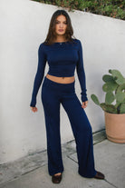 Woman wearing the TIC TOC PH31588BA SORA navy fold over straight leg leggings featuring a low rise waistline, smooth stretch fabric, and straight leg finish with the matching top outdoors.
