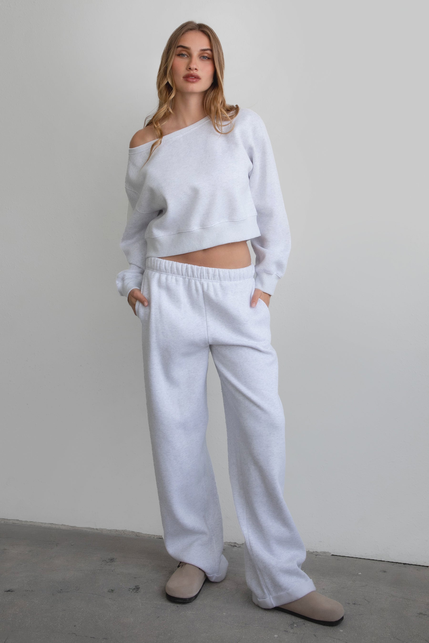 Woman wearing the TIC TOC PJ30241 LANI ash cloud fleece wide leg sweatpants featuring a straight leg silhouette, drawcord waistband, and side pockets paired with a matching sweater.