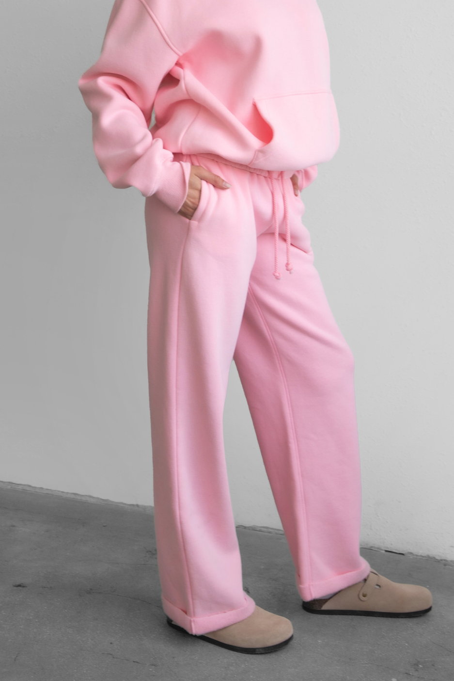 Woman wearing the TIC TOC PJ30241 LANI blush cloud fleece wide leg sweatpants featuring a straight leg silhouette, drawcord waistband, and side pockets paired with a matching sweater.