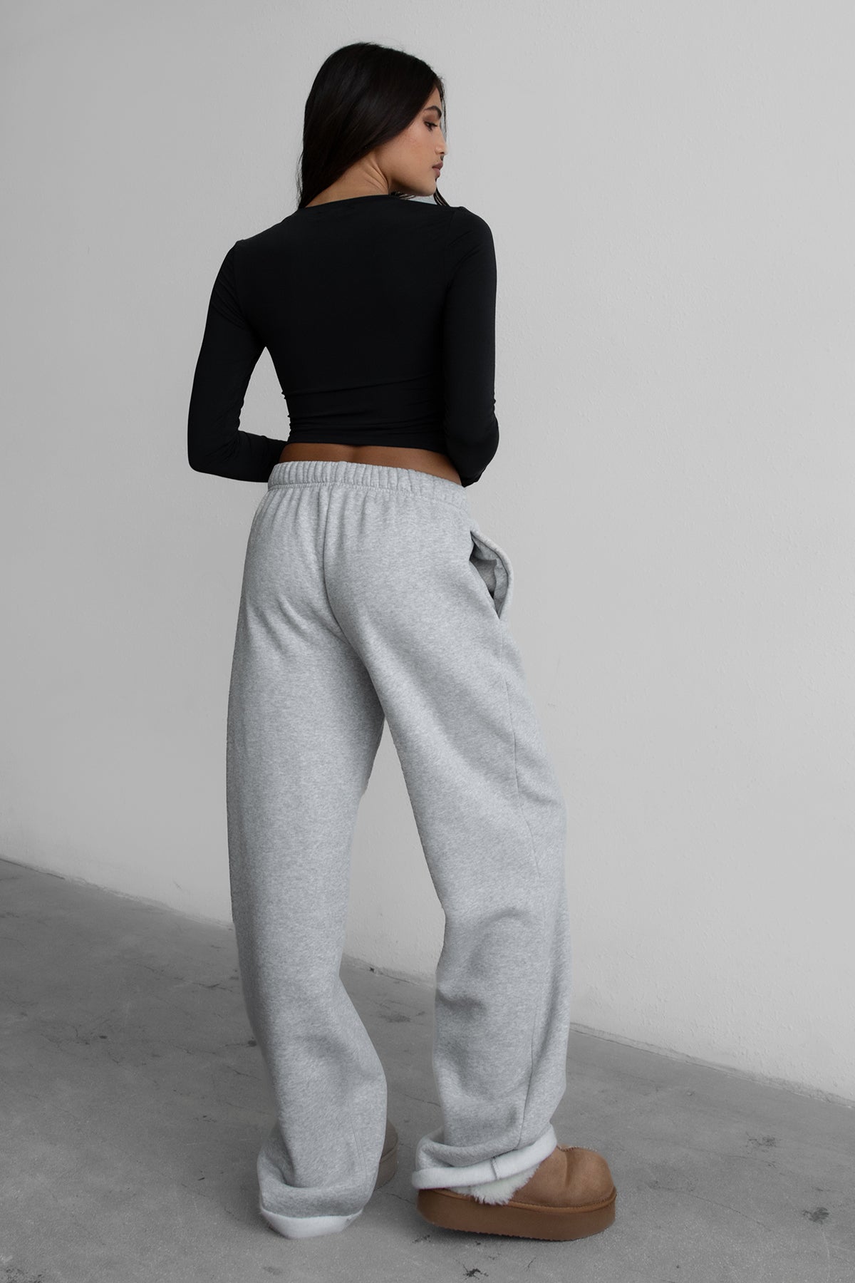 Woman wearing the TIC TOC PJ30241 LANI heather grey cloud fleece wide leg sweatpants featuring a straight leg silhouette, drawcord waistband, and side pockets paired with a matching sweater.