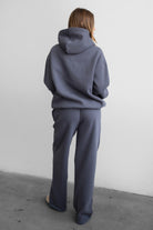 Woman wearing the TIC TOC PJ30241 LANI steel grey cloud fleece wide leg sweatpants featuring a straight leg silhouette, drawcord waistband, and side pockets paired with a matching sweater.