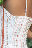Close-up of a person wearing a patterned dress with a blurred background