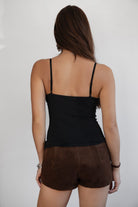 Woman wearing TIC TOC TH31525 SHYNETTE hand-beaded sequin cami top with lace trim neckline and adjustable straps paired with brown suede mini shorts