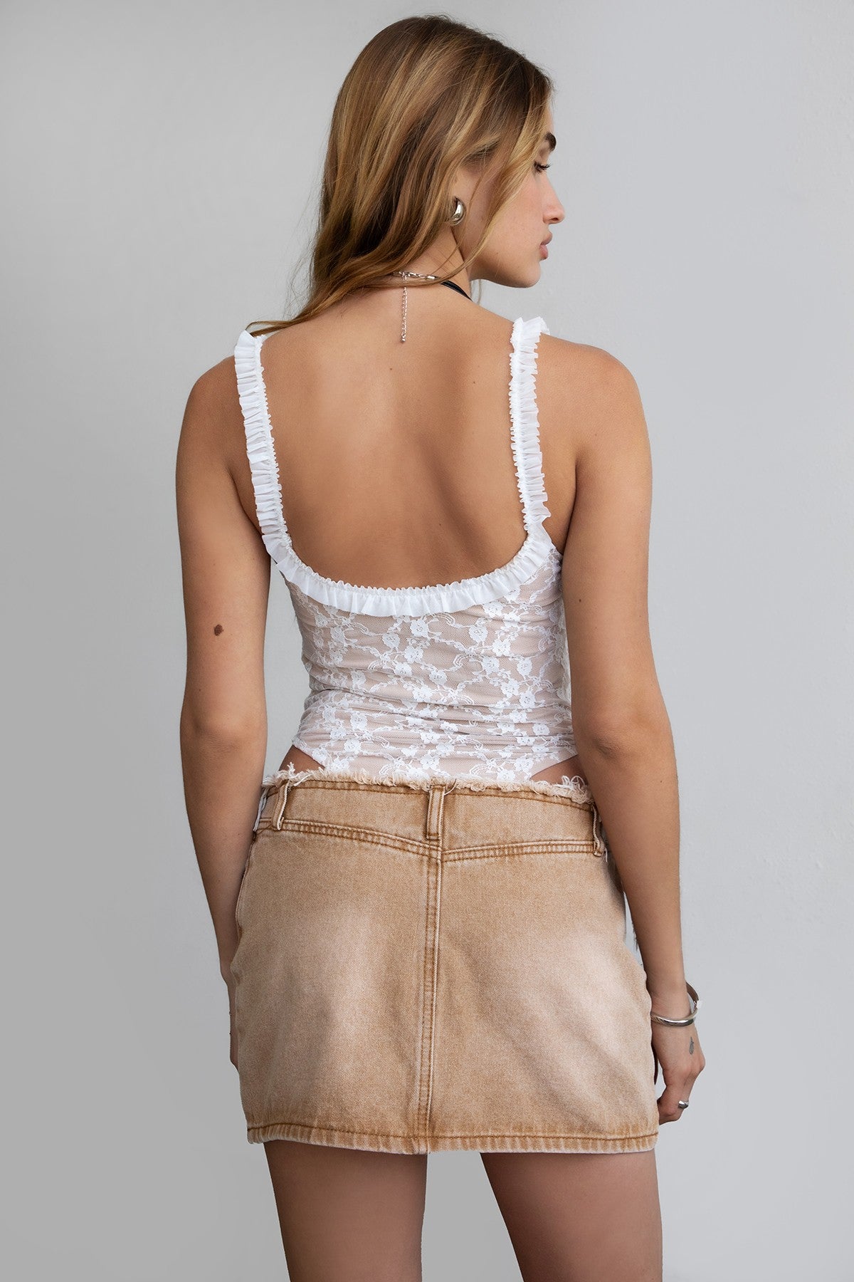 White nude mesh lace bodysuit featuring high-cut thong bottom and snap closure