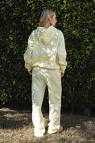 Woman wearing the TIC TOC TJ31007 DAMI pale yellow cloud fleece oversized hoodie featuring a dropped shoulder design, kangaroo pocket, and ribbed cuffs with matching bottoms.